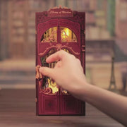 DIY book nook kit called “Chronicles Sanctuary,” featuring a richly detailed miniature library scene with shelves, staircase, and glowing lights. Ideal for book nook collectors, DIY and crafts fans, and lovers of tiny dollhouses and DIY mini home kits.