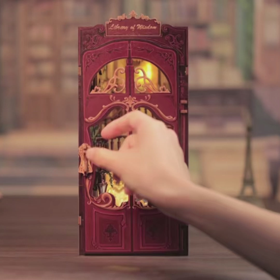 DIY book nook kit called “Chronicles Sanctuary,” featuring a richly detailed miniature library scene with shelves, staircase, and glowing lights. Ideal for book nook collectors, DIY and crafts fans, and lovers of tiny dollhouses and DIY mini home kits.