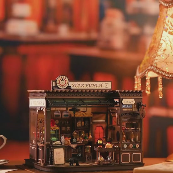 DIY miniature kit featuring “Potion Patisserie,” a whimsical cake and potion shop. Includes magical decor, sweets, golden teapots, and a black cat. Ideal for DIY and crafts lovers, fantasy collectors, and tiny dollhouse hobbyists.