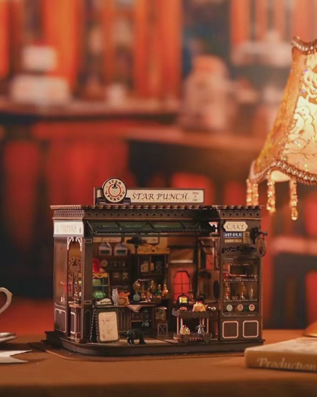 DIY miniature kit featuring “Potion Patisserie,” a whimsical cake and potion shop. Includes magical decor, sweets, golden teapots, and a black cat. Ideal for DIY and crafts lovers, fantasy collectors, and tiny dollhouse hobbyists.