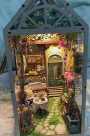 DIY garden book nook kit featuring a miniature outdoor café, greenery, tiny table setup, and rustic path — perfect for miniature lovers, DIY crafts, book nook fans, and small DIY house decor.
