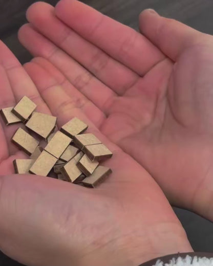 DIY book nook of a Japanese-style tea alcove featuring a glowing paper lantern, bonsai rock garden, shoji screen doors, bookshelves, and a peaceful wooden table, evoking the quiet ambiance of a neighborhood tea house.