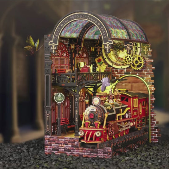 DIY book nook kit “Platform Arcane,” featuring a mechanical fantasy train station with glowing lights, gears, arched glass roof, red locomotive, and magical details. Ideal for DIY and crafts lovers, fantasy readers, and miniature train enthusiasts.