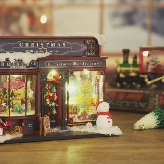 DIY miniature Christmas shop called “Jolly & Pine Christmas Shoppe,” featuring snow-dusted rooftops, holiday lights, a sleigh, Christmas tree, and cozy window displays. Ideal for holiday crafts, DIY mini home kits, and miniature house collectors.