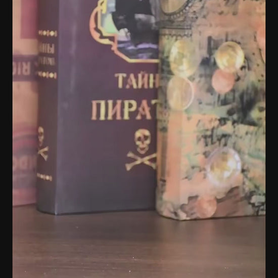 DIY book nook miniature kitchen with Mediterranean tiles, hanging copper pots, red oven, and open blue shutters.