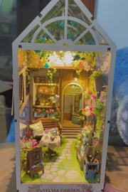 DIY garden book nook kit featuring a miniature outdoor café, greenery, tiny table setup, and rustic path — perfect for miniature lovers, DIY crafts, book nook fans, and small DIY house decor.
