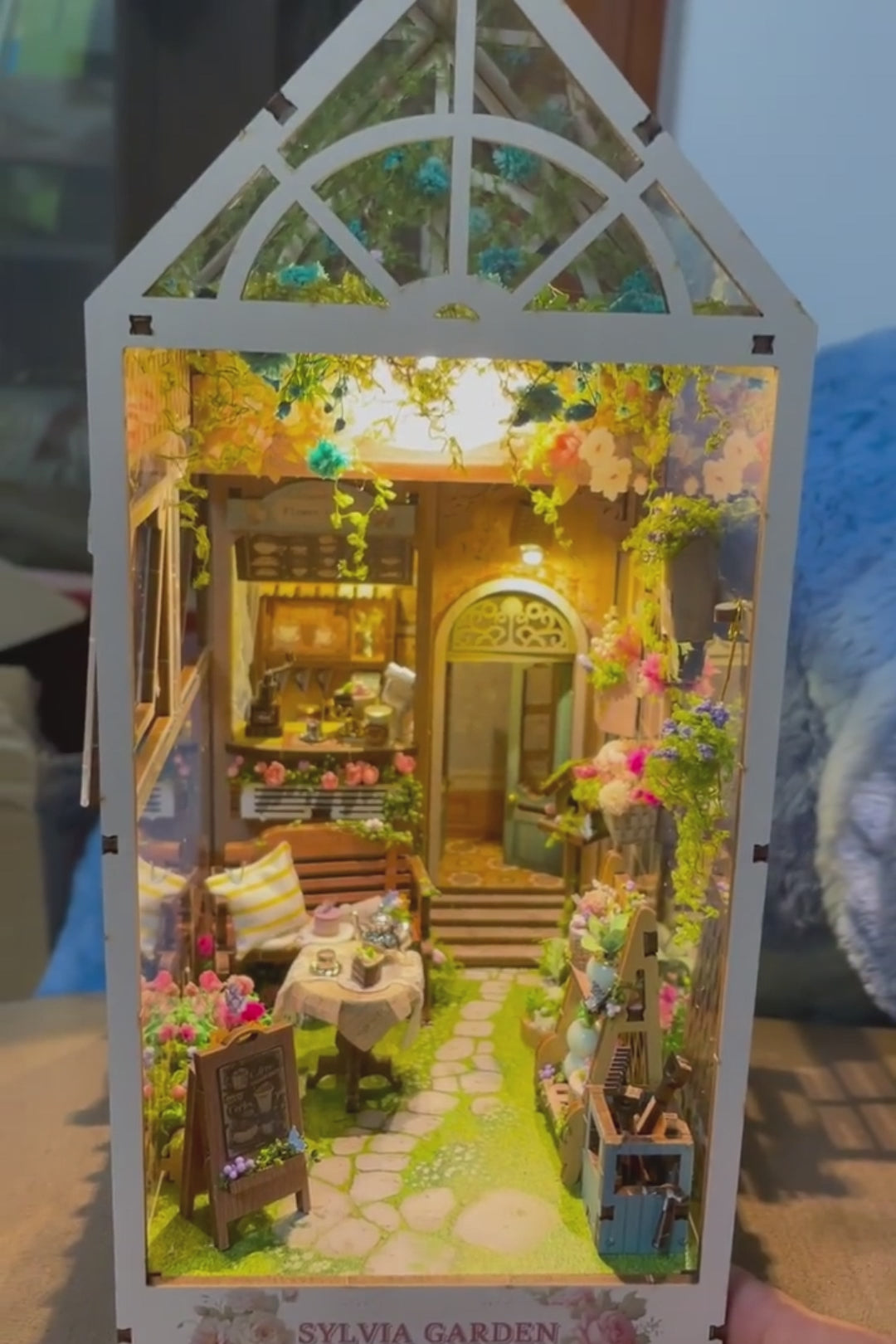 DIY garden book nook kit featuring a miniature outdoor café, greenery, tiny table setup, and rustic path — perfect for miniature lovers, DIY crafts, book nook fans, and small DIY house decor.