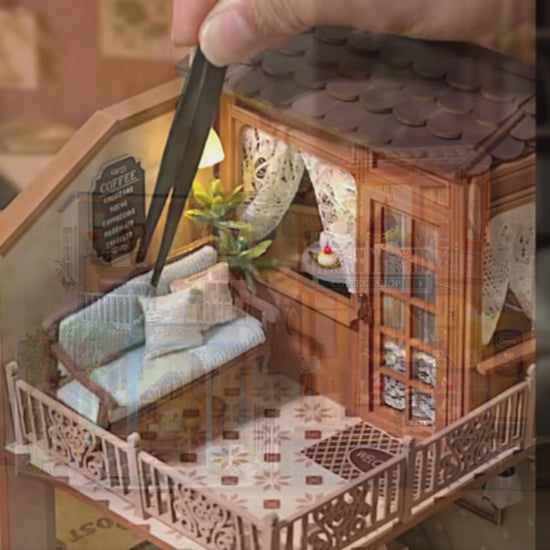DIY mini house kit “Perch & Latte Loft,” featuring a cozy two-story coffee shop with a glowing café interior, reading nook, lace-curtained loft, and tiny desserts. A warm and detailed build for DIY and crafts lovers and fans of miniature homes.